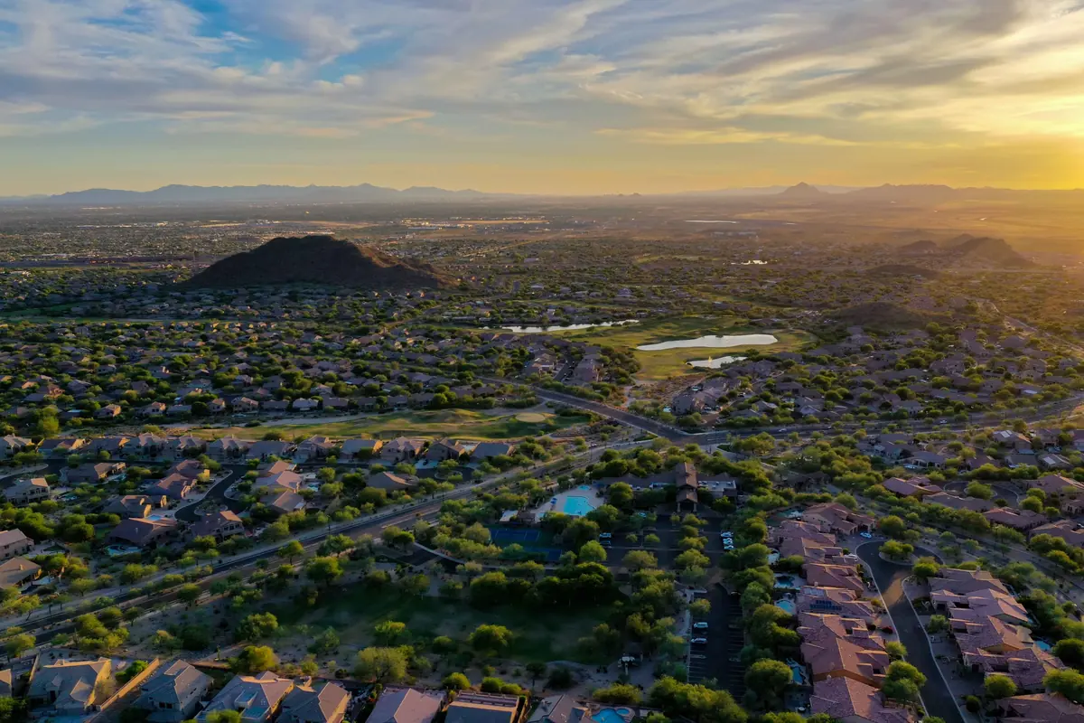 Aerial view of the Valley city lights at twilight with mountains on the horizon