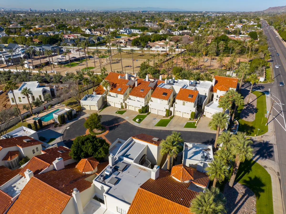 Aerial view of Scottsdale-area homes with tile roofs, backyard pools and palm trees